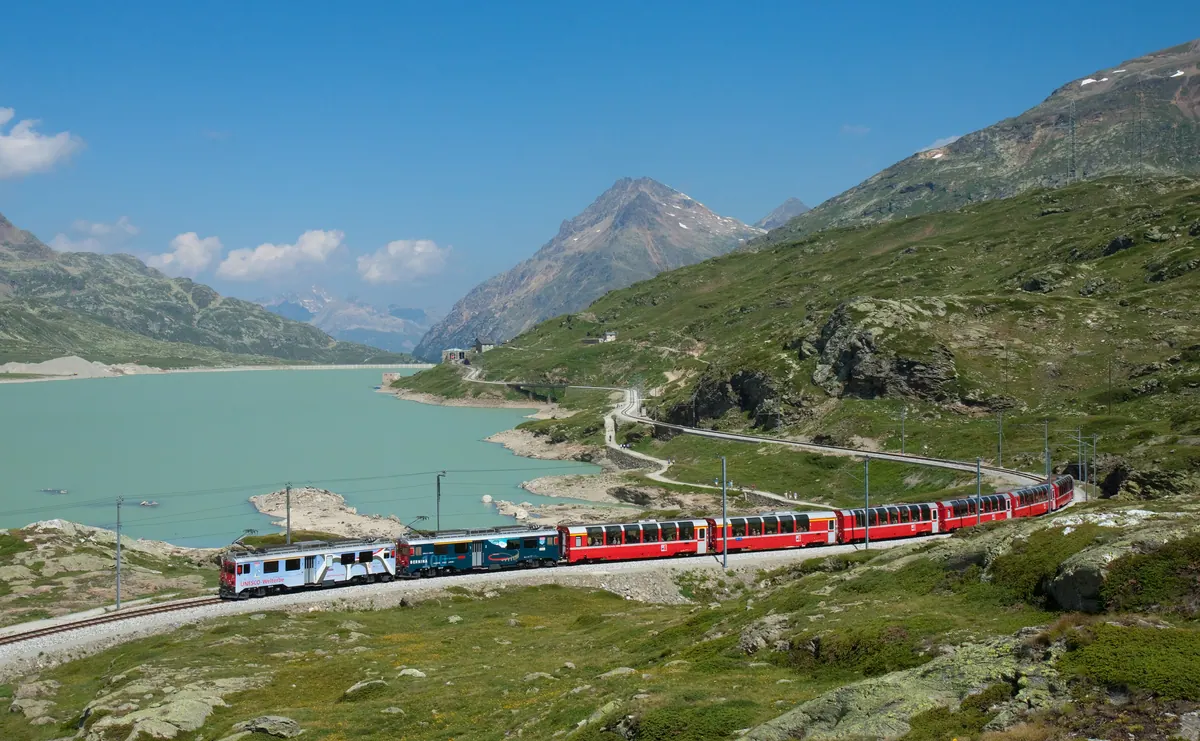 The Bernina Express beside Lago Bianco on the Bernina Pass, the highest part of the St Moritz to Tirano section